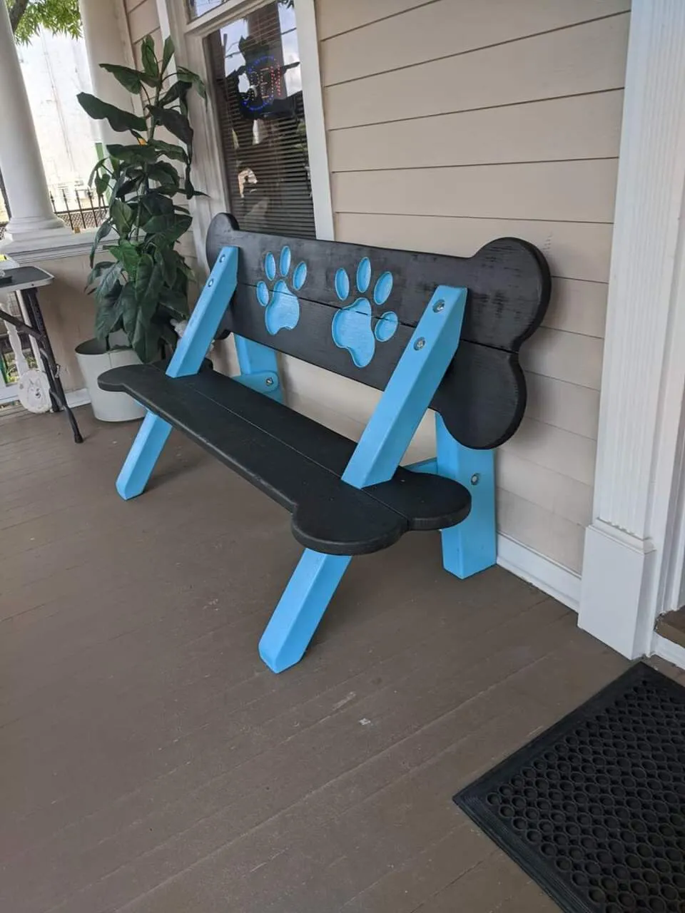 Bench with paw prints on porch.
